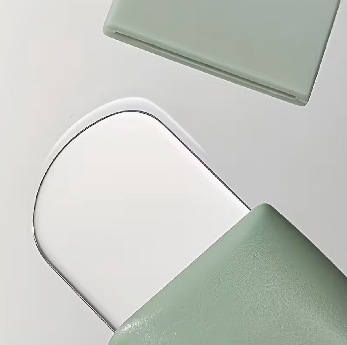 Light green textured facial pore cleanser brush with ergonomic handle for blackhead removal and gentle skin cleansing.