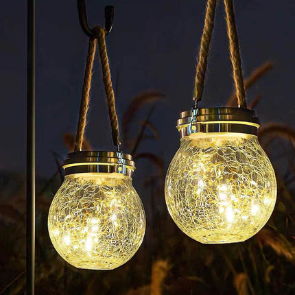 Outdoor solar LED courtyard light with cracked glass ball illuminating a garden pathway at night