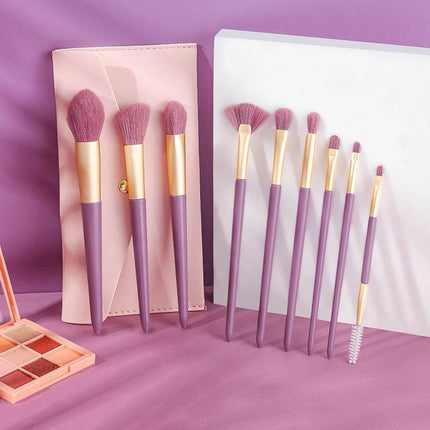 10-piece purple makeup brush set with synthetic fibers and matching storage bag