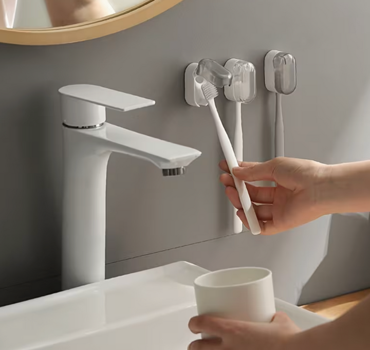Plastic wall-mounted toothbrush holder by UK Dropships, no-drill dustproof organizer for bathroom and travel storage.