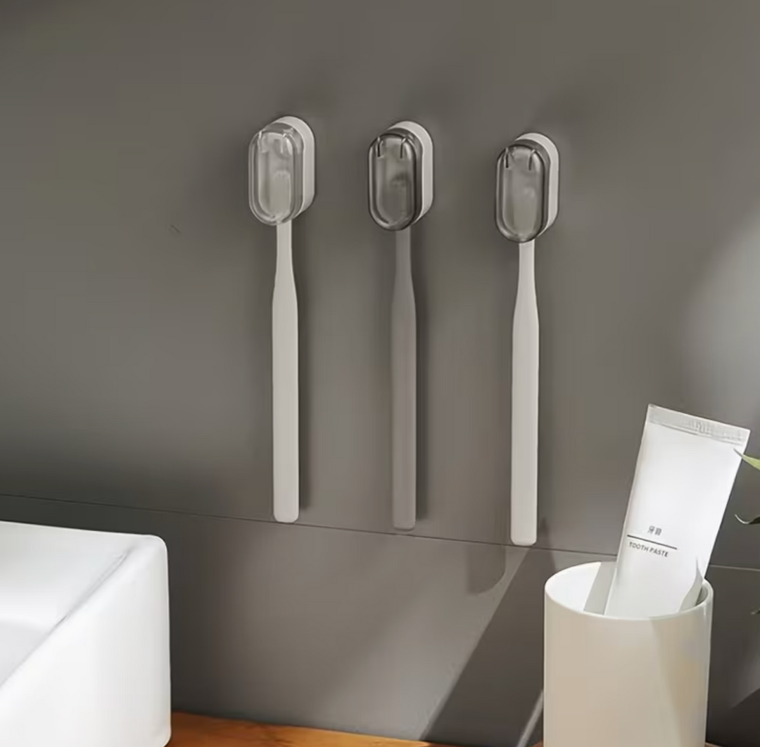 Plastic wall-mounted toothbrush holder by UK Dropships, no-drill dustproof bathroom organizer with easy carry storage box.