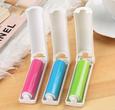 Colorful lint rollers and dust remover brushes in pink, blue, green, and yellow for pet hair and lint removal