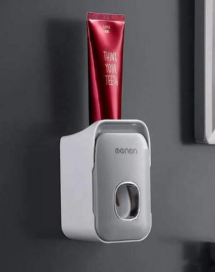 Compact toothpaste holder with adhesive mount for easy tube squeezing and bathroom organization