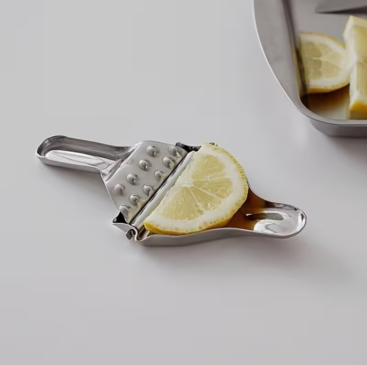 Stainless steel manual citrus juicer with ergonomic handle for easy juice extraction, ideal for home and garden use.