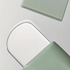 Light green textured facial pore cleanser brush with ergonomic handle for blackhead removal and gentle skin cleansing.
