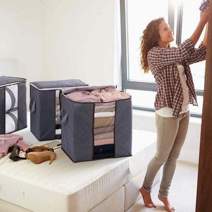 Stacked dustproof storage bags in grey, dark blue, and beige white for bedding and clothes organization