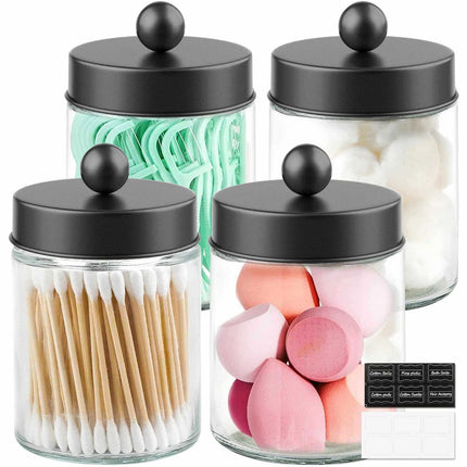 Set of 4 glass apothecary jars with lids and black labels for bathroom storage and decor
