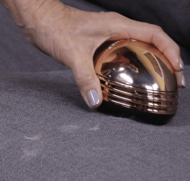 Gold portable mini desktop vacuum cleaner with cute compact design on office desk