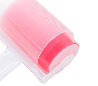 Colorful lint rollers and dust remover brushes in pink, blue, green, and yellow for pet hair and lint removal