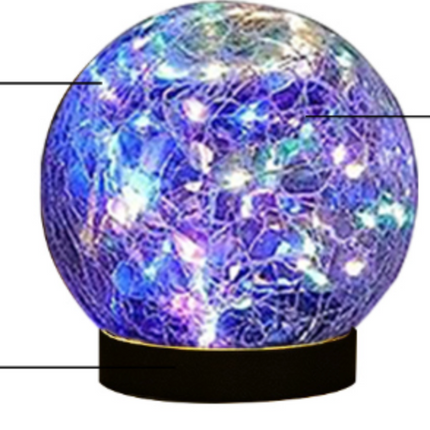 Solar Crackle Ball Light glowing warmly in garden at night powered by solar panel