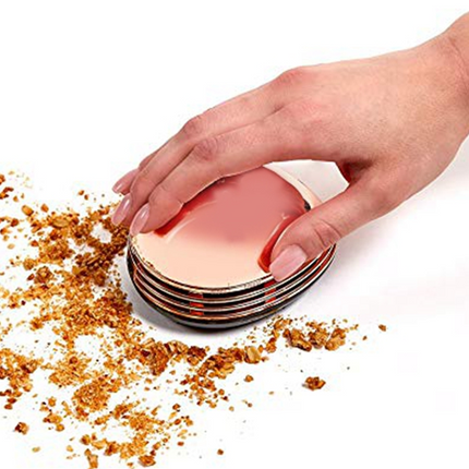 Gold portable mini desktop vacuum cleaner with cute design on a desk