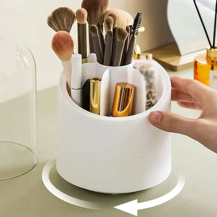 360° rotating makeup brush organizer with multiple compartments in white, pink, and blue colors on vanity table