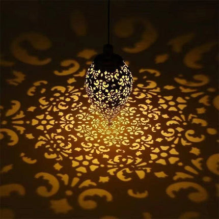 Solar LED wall light mounted on outdoor garden wall illuminating pathway