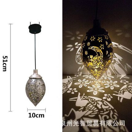 Solar LED wall light mounted outdoors illuminating garden pathway with warm white light