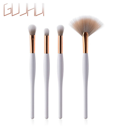 8-piece makeup brush set with black handles and silver tubes arranged on white background