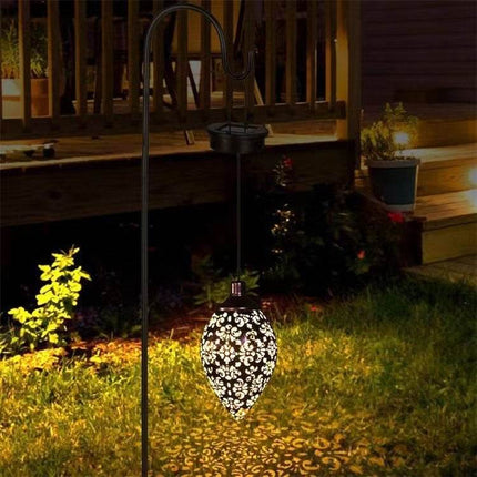 Solar LED wall light mounted on outdoor garden wall with warm white illumination
