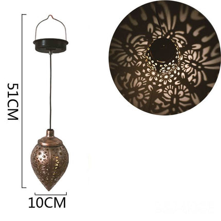 Solar LED wall light mounted on garden wall with warm white illumination