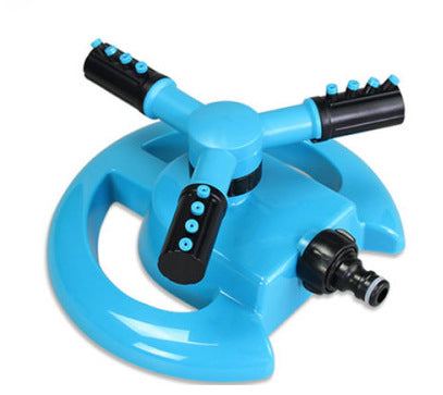 Automatic rotary sprinkler irrigating lawn and vegetable garden with adjustable rotary nozzle and vibrant green color