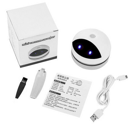 Compact Robot Desktop Vacuum cleaner with USB charging on a desk