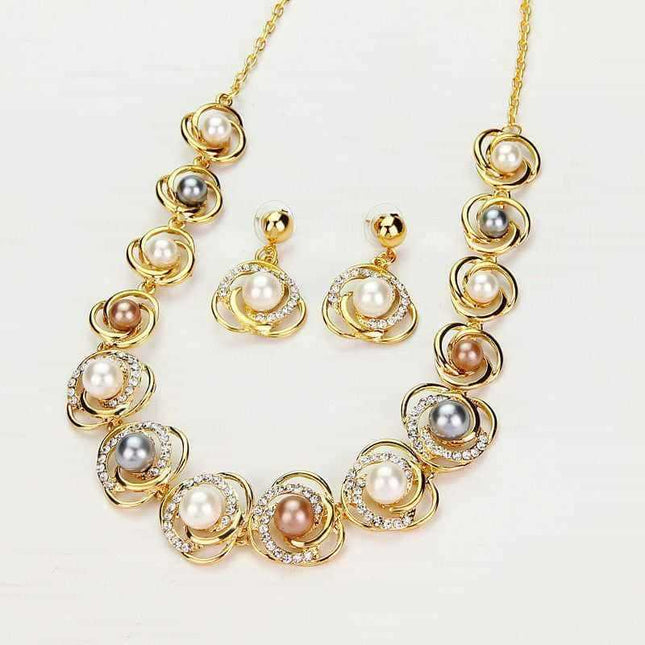 Saturn ring necklace set with matching pearl earrings on white background