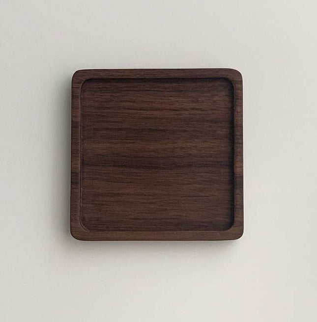 Unpainted Japanese Walnut wooden coaster with natural grain, round shape, wax-free finish for insulated dessert serving